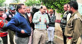 Residents of the locality try to reason with a policeman.