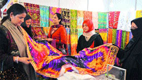 Women look at dress material at a stall during the Indo-Pak International Trade Expo in Ludhiana on Friday.