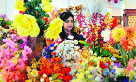 A visitor looks at flowers at a stall during the Indo-Pak International Trade Expo, which began on Friday.