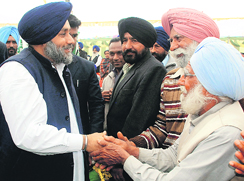 SAD president Sukhbir Badal interacts with villagers in Moga on Friday. 