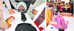 District and Sessions Judge HS Madaan donates blood during a camp. (Right) A student of Khalsa college donates blood at another camp in Amritsar on Saturday. Tribune Photos 