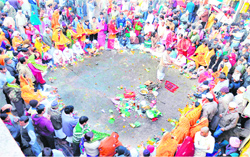 People take part in religious rituals at the Ganga ghat in Haridwar on Saturday. Tribune photo: Rameshwar Gaur