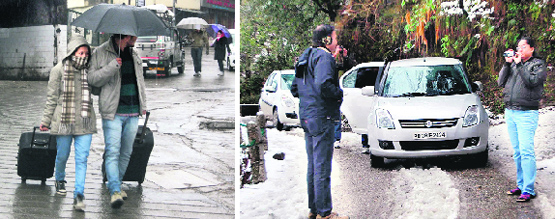 Tourists enjoy snowfall at Lal Tibba in Mussoorie on Saturday (L) and Tourists walk in the rain in Mussoorie on Saturday.