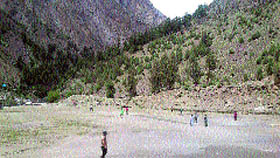 Boys play cricket in the incomplete sports stadium at Udaipur in Lahaul-Spiti district.
