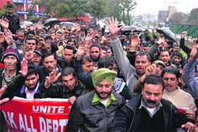 Members of the J&K All Department ITI and Non-ITI Daily Rated Workers United Front protest in support of their demands in Jammu on Saturday