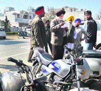Mayor Harcharan Singh Gohalwaria checks parking slips at Childrens Traffic Park.