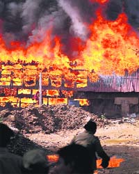 A fire at a shelter of construction workers near the venue of the Australia-India A cricket match, in Chennai on Saturday