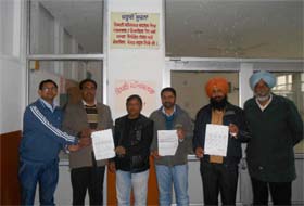 Members of the Master Cadre Union showing their charter of demands in Bathinda on Sunday