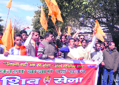 Shiv Sena workers hold a protest against the alleged black marketing of LPG in Dehradun on Sunday.