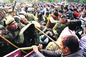 Members of the Patrata Adhyapak Sangh, Haryana, grapple with the police to cross the barricades to submit a memorandum to Chief Minister Bhupinder Singh Hooda through the Deputy Commissioner in Rohtak on Sunday. 