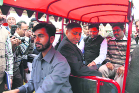 A youth drives his newly acquired battery-driven auto-rickshaw with MP Ashok Tanwar and DC J Ganesan on the back seat in Sirsa on Sunday.