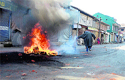 Protesters burn tyres during a strike called by the Hurriyat in Srinagar on Sunday