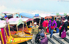 A group of tourists near the Dal Lake after curfew was lifted from Srinagar and some other parts of the Valley on Sunday