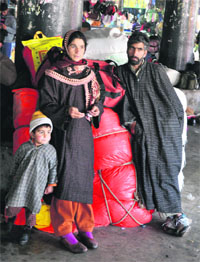 A family stranded at the bus stand in Jammu due to snowfall in Kashmir.