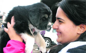 A girl seems happy with her newly bought pup