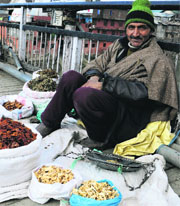 A roadside vendor waits for customers at Amirakadal in Srinagar on Sunday.