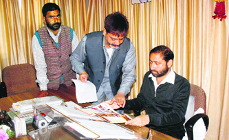 Sanjay Chopra, president of the Uttarakhand Small Traders Association, presents a memorandum to Urban Development Minister Preetam Singh Panwar in Dehradun on Monday, demanding the implementation of the vendors policy.
