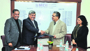 Prof Anand Mohan (second from right), Director, National Institute of Technology, Kurukshetra, and Prof Mukul Gupta (second from left) Director, Management Development Institute (MDI), Gurgaon, exchange documents at MDI, Gurgaon. 