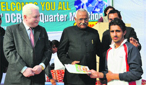 Vice-Chancellor HS Chahal gives away a prize to Rahul, one of the winners of the Quarter Marathon, organised by the Deenbandhu Chhotu Ram University of Science and Technology, Murthal. 