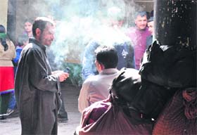 Ban up in smoke: Despite ban on smoking in public, men smoke at the bus stand in Jammu