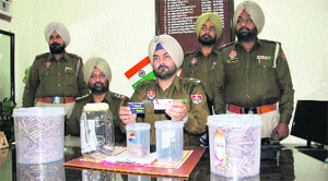 A police team with the goods and weapons recovered from arrested gang members in Phagwara on Monday. 