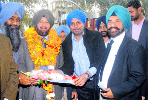 Dubai-based businessman SPS Oberoi being honoured by NRI Sabha president JS Gill in Jalandhar on Monday. 