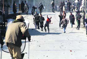 Protesters throw stones at security personnel at Kulgam on Monday