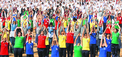 Schoolchildren perform surya namaskar (sun salutation) during a function to mark the 150th birth anniversary of Swami Vivekananda in New Delhi on Monday. 