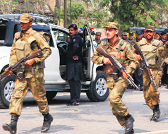 Pakistan army soldiers rush to the scene of the bombing in Peshawar on Monday.