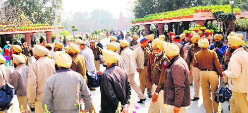 Punjab Police personnel deployed outside the Jallianwala Bagh ahead of British Prime Minister David Camerons visit to Amritsar. A policeman frisks a visitor and premises of Jallianwala Bagh being spruced up on Tuesday.