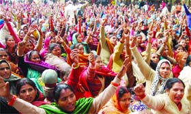 Anganwadi workers shouting slogans during a dharna for their demands at Jantar Mantar in New Delhi on Tuesday
