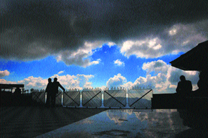 People look at the dark clouds in Shimla on Monday. 