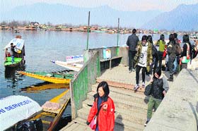 A group of tourists on the banks of the Dal Lake in Srinagar on Tuesday