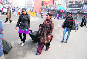 With several roads remaining blocked for four-wheeler traffic, tourists forced to leave their cabs. Policemen stop a bus from proceeding ahead in Amritsar on Wednesday.