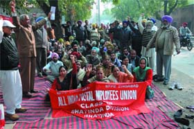 Employees of the postal department hold a demonstration under the banner of the All India Postal Employees Union