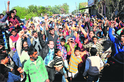 Residents block the entrance to the village during a protest against a demolition drive at Khuda Lahora on Wednesday. Tribune photo: PArvesh Chauhan
