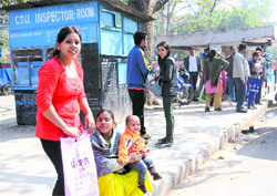 Harassed residents wait for buses in Sector 12, Chandigarh, on Wednesday. 