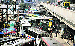 Private buses parked haphazardly outside the bus stand