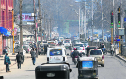 Private vehicles and some buses ply on roads during a strike call given by Hurriyat Conference leader Syed Ali Shah Geelani, in Srinagar on Wednesday. Tribune photo: Amin War