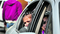 A girl looks out of the window of a car during a traffic jam in Ludhiana on Wednesday