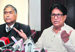 Civil Aviation Minister Ajit Singh (R) with secretary KN Shrivastava at a press conference in New Delhi on Wednesday.