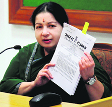 VICTORY: Tamil Nadu Chief Minister J Jayalalithaa shows the copy of the gazette on Cauvery Water Disputes in Chennai on Wednesday. 