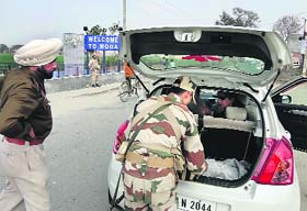Security personnel check a vehicle in Moga on Wednesda