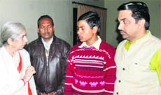 Former Health Minister Laxmi Kanta Chawla (left) at a press conference with 13-year-old boy Sunil Kumar (second from right), who was rescued from a farmers house at Bandala village, near Jandiala, in Amritsar on Thursday.