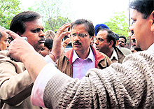 Shopkeepers argue with officials of the enforcement wing in Sector 22, Chandigarh, on Thursday