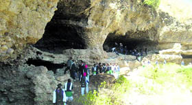 Students of Government Inter-College, Godhakhori, at the historic caves of Lakhamandal during an educational trip.