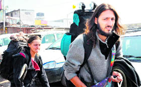 Two European tourists look for a private taxi as there was no bus service due to the strike by labour unions in Haridwar on Thursday.
