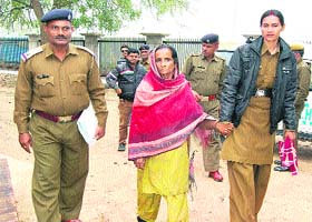 Jasbir Kaur, who allegedly throttled her five-hour-old granddaughter to death, is produced before a court in Sirsa on Thursday