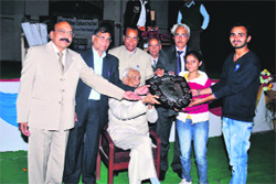 Ram Labhaya Guliani (on chair), former president of Markanda National College, Shahabad-Markanda, gives away the Prof Rajeshwar Shokh memorial poetical recitation trophy to the winning team of Government College, Ambala Cantonment. Photo: DR Vij 