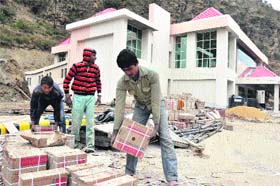 Workers engaged in construction at the Patanjali Yogpeeth site at Sadhupul in Solan district on Thursday